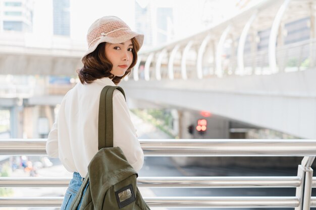 Attractive young smiling Asian woman outdoors portrait in the city