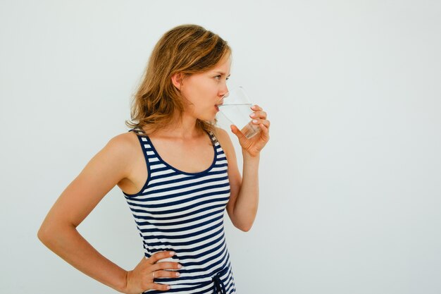 Attractive Young Woman Drinking Water From Glass