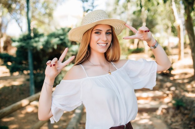 Attractive young woman enjoying her time outside in park with sunset in background.