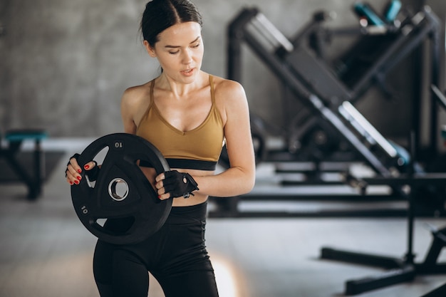 Attractive young woman exercising at the gym