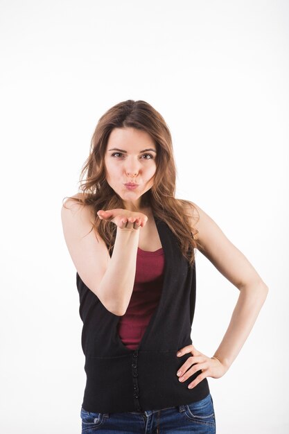 Attractive young woman giving flying kiss