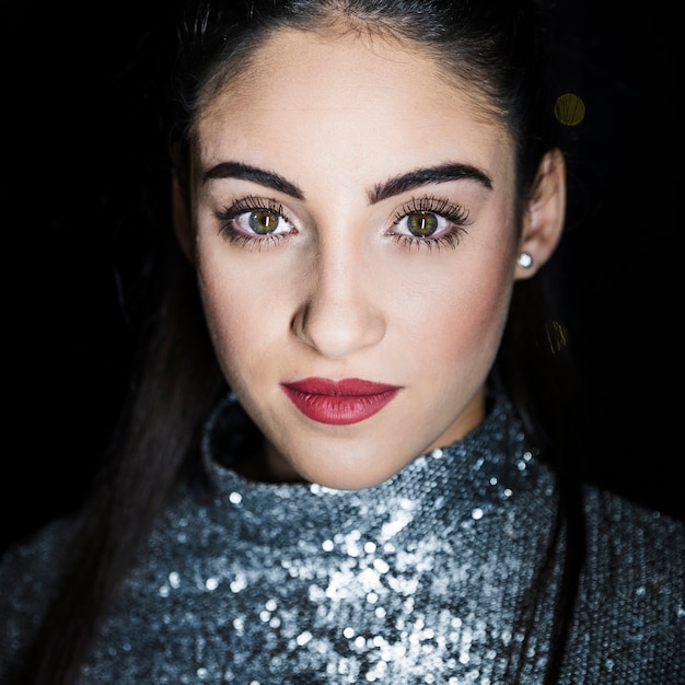 Attractive young woman in glittering dress