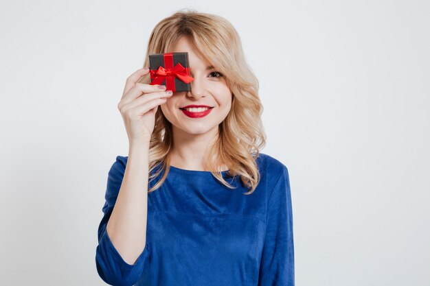 Attractive young woman holding gift