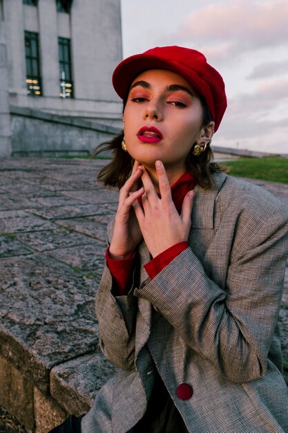 An attractive young woman touching her chin looking at camera