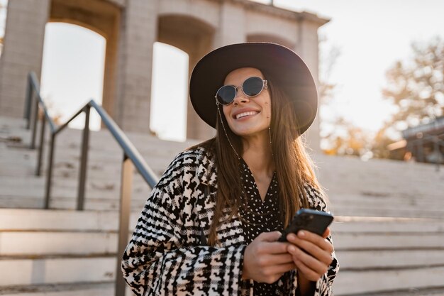 Attractive young woman walking in autumn wearing coat