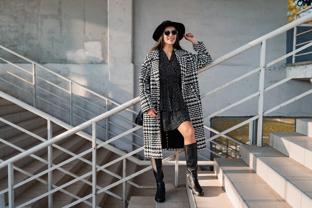 Attractive young woman walking in autumn wearing coat