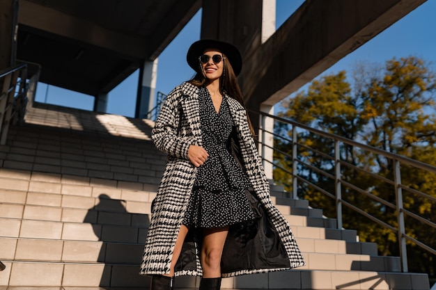 Attractive young woman walking in autumn wearing coat