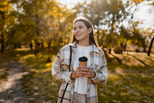 Attractive young woman walking in autumn wearing jacket