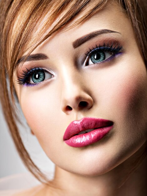 Free photo attractive young woman with beautiful big blue eyes. closeup face of an amazing girl with sexy lips.