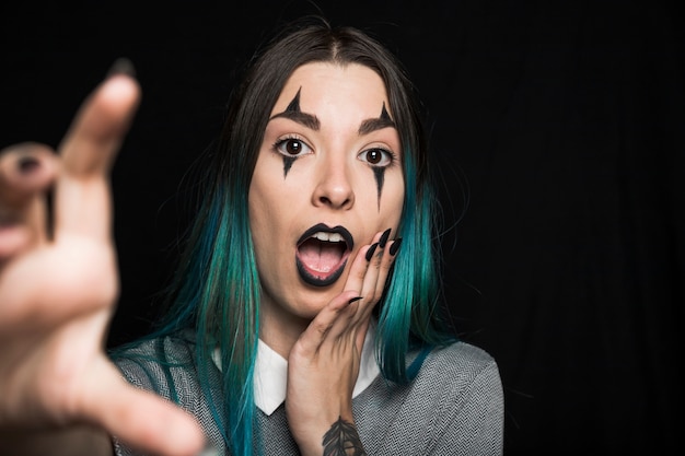 Attractive young woman with harlequin makeup