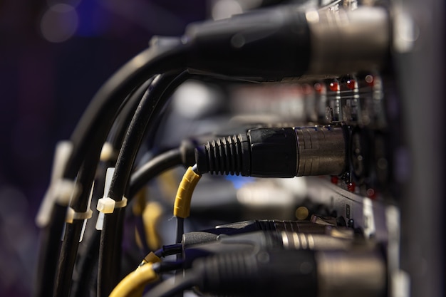 Audio snake and stage box with xlr cables and jacks at a live show.