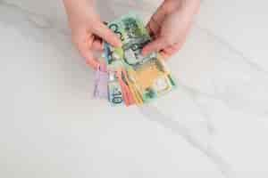 Free photo australian dollar banknotes in the hands. on the white background