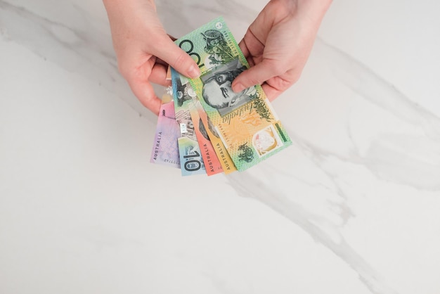 Australian dollar banknotes in the hands. on the white background