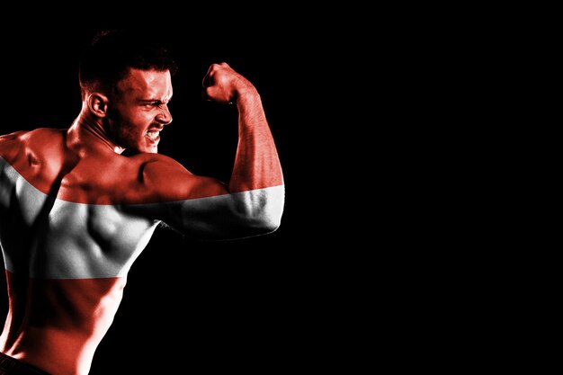 Austria flag on handsome young muscular man black background