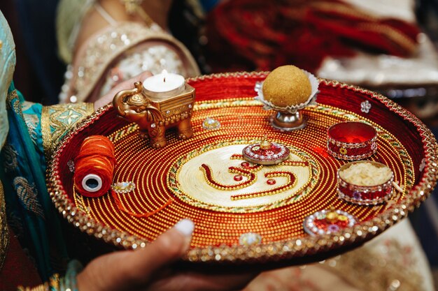 Authentic indian tray with traditional sacred objects for wedding ceremony