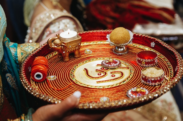 Authentic indian tray with traditional sacred objects for wedding ceremony