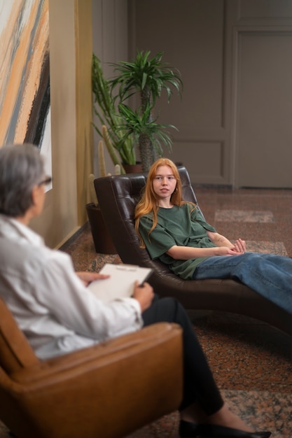 Authentic scene of young person undergoing psychological therapy