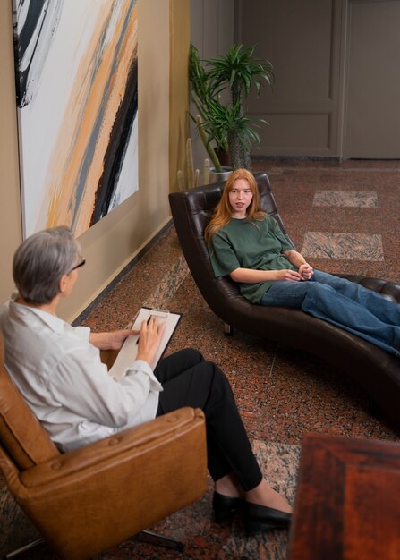 Authentic scene of young person undergoing psychological therapy