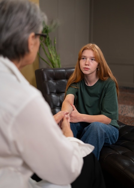authentic scene of young person undergoing psychological therapy