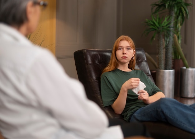 Free photo authentic scene of young person undergoing psychological therapy