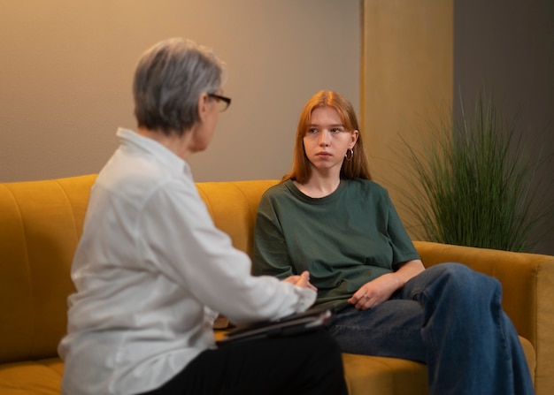 Authentic scene of young person undergoing psychological therapy