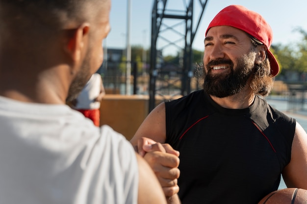 Free photo authentic scenes of plus-size males playing basketball