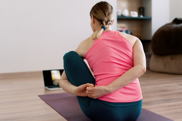 Authentic woman practicing yoga at home