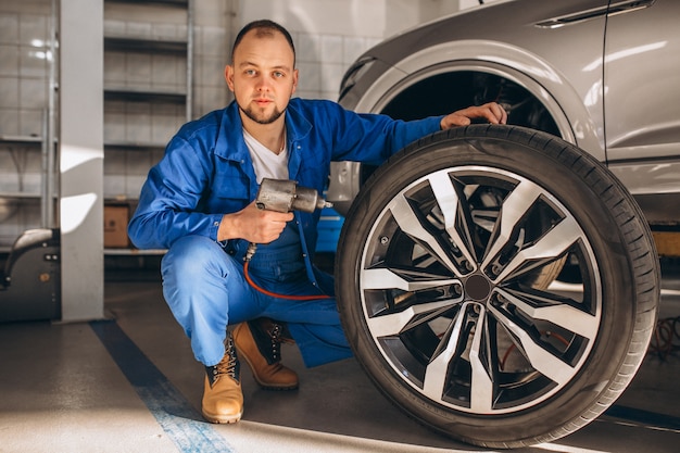 Auto mechanic checking car