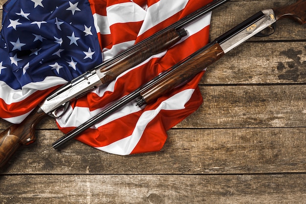 Automatic rifle on usa flag on wooden background