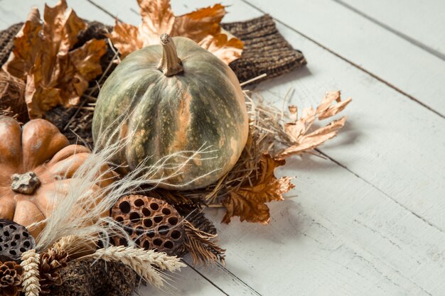 Autumn background with decorative items and pumpkin.