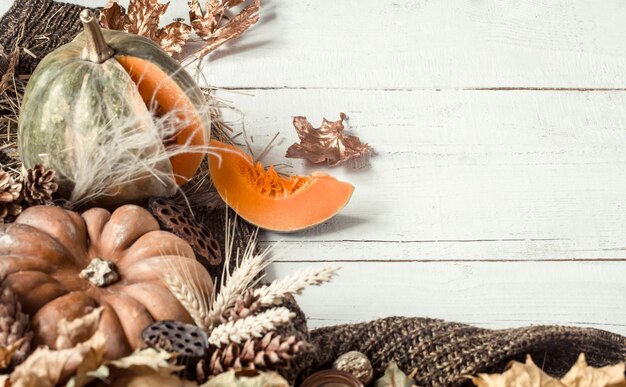 Autumn background with decorative items and pumpkin.