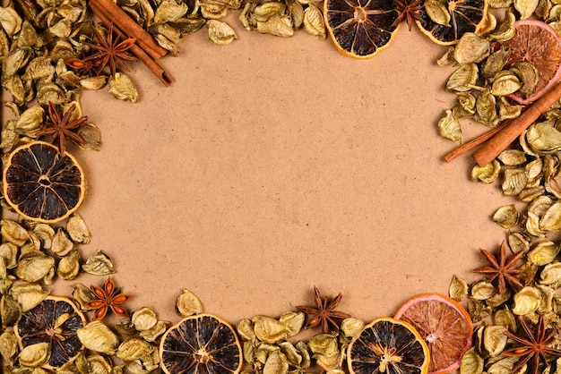 Autumn background with golden leaves, dried fruts, cinnamon and anis. space for text or design.