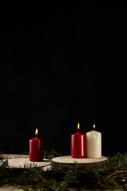 Autumn candles over wood slices with yew