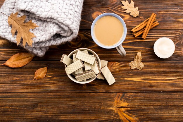 Autumn coffee and wafers layout on wooden background