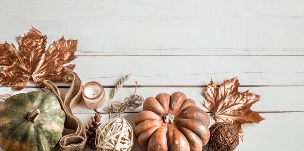 Autumn composition with decorative items and pumpkins