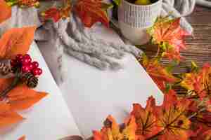 Free photo autumn composition with open book on table