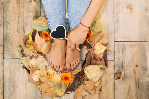 Autumn concept with legs in circle of leaves