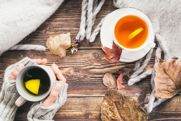 Autumn drinks and scarf on table