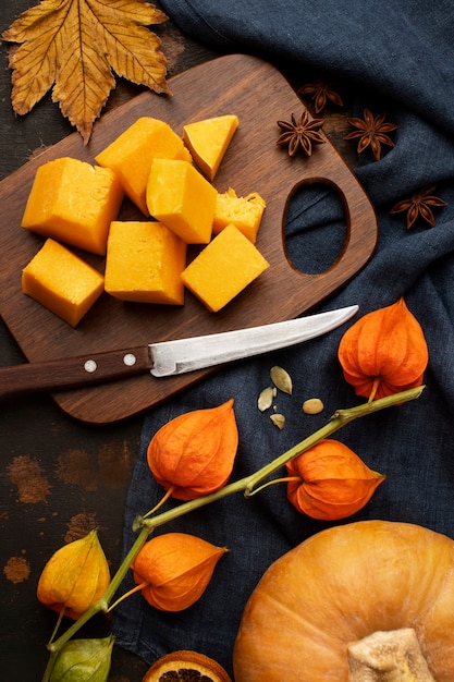 Autumn food slices on wooden board of pumpkin high view