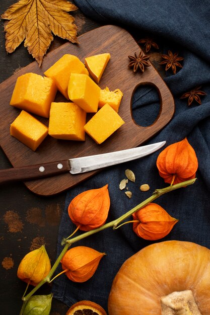 Autumn food slices on wooden board of pumpkin high view
