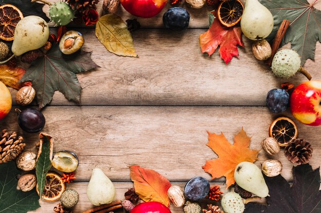 Autumn frame composition with harvest on wooden background