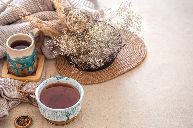 Free photo autumn home composition with a beautiful ceramic cup of tea on the table. decorative items in the interior.