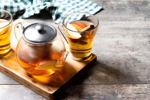 Free photo autumn hot apple drink with spices on wooden table