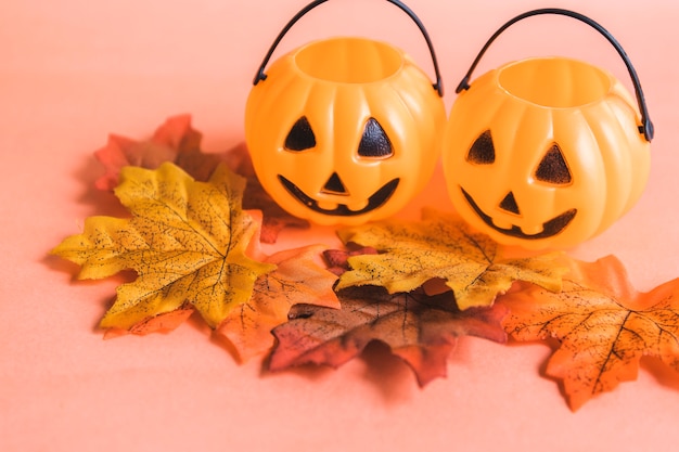 Autumn leaves near jack-o-lantern baskets