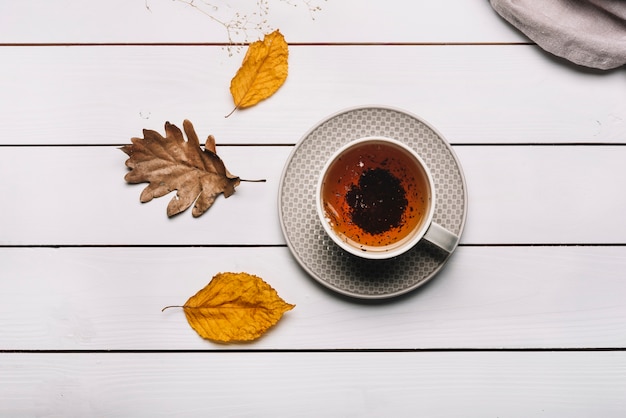 Autumn leaves near tea