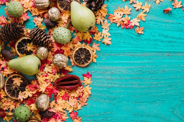 Autumn leaves and organic products on blue background