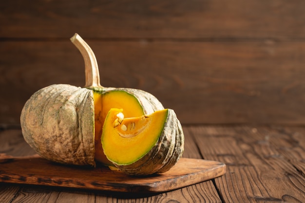 Autumn pumpkin on wooden table.