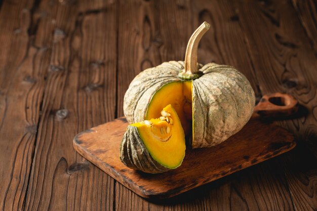Autumn pumpkin on wooden table.