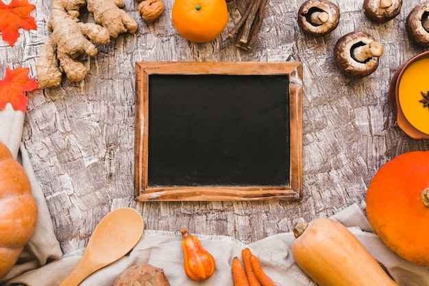 Free photo autumn symbols around blackboard