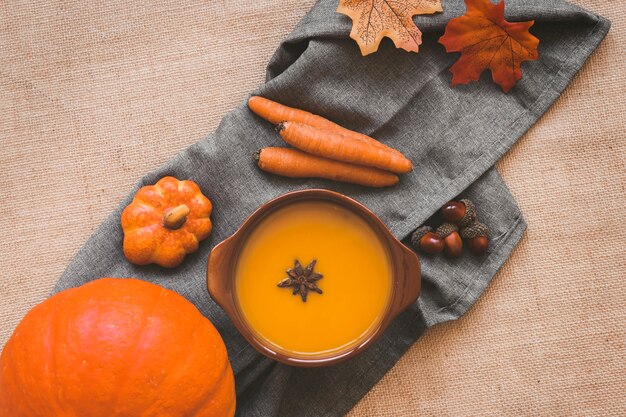 Autumn vegetables and carrots near soup